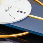 Modern luxury wall clock with gold accents and sleek design.