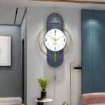 Modern luxury wall clock with gold accents in a stylish living room setting.