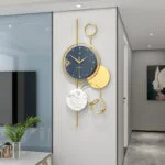 Modern luxury wall clock with gold accents in a stylish living room.