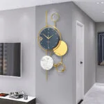 Modern luxury wall clock with gold accents in a stylish living room.