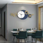 Modern luxury wall clock with gold accents in a stylish dining room setting.