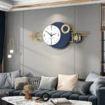 Modern luxury wall clock with geometric design in a stylish living room setting.