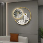 Modern illuminated wall clock with astronaut design in a luxury living room setting.
