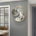 Modern wall clock with astronaut design and gold accents, perfect for luxury home decor.