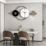 Modern luxury wall clock with geometric design above dining table in stylish home decor setting.
