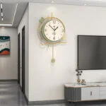 Modern luxury wall clock with gold accents in a stylish living room setting.