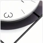Close-up of a modern decorative wall clock with minimalist design.