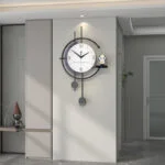 Modern luxury wall clock with pendulum in a stylish hallway setting.
