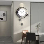 Modern decorative wall clock with pendulum in a stylish dining room setting.
