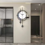 Modern luxury wall clock with pendulum in a stylish home interior.