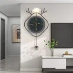 Modern wall clock with antler design in a stylish living room setting.