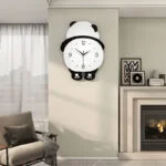 Modern panda-shaped wall clock in a stylish living room setting.