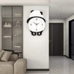 Modern panda-shaped wall clock in a stylish living room setting.