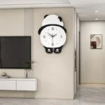Modern panda-shaped wall clock in a stylish living room setting.
