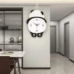 Modern panda-shaped wall clock in a stylish kitchen and dining area.