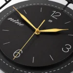 Modern luxury wall clock with gold hands and black face, perfect for home decor.
