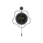 Modern decorative wall clock with unique design and black finish.