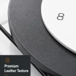 Close-up of a modern wall clock with premium leather texture and clear finish.