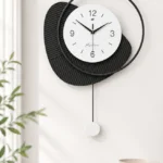 Modern black and white wall clock with abstract design, perfect for luxury home decor.
