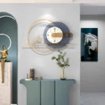 Modern luxury wall clock with gold accents and decorative ornaments in a stylish home interior.