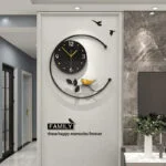 Modern decorative wall clock with bird design and family quote in a stylish living room.