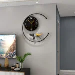 Modern decorative wall clock with bird design in a stylish living room setting.