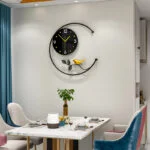 Modern decorative wall clock with bird design in a stylish dining room.