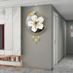 Modern decorative wall clock with floral design and star accents in a luxury home hallway.