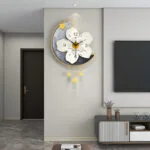 Modern decorative wall clock with floral design in a luxury living room setting.