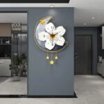 Modern decorative wall clock with floral design and star accents in a luxury home setting.