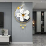 Modern decorative wall clock with floral design and star accents in a luxury home setting.