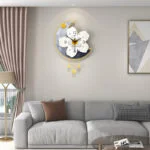 Modern decorative wall clock with floral design in a luxury living room setting.