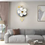 Modern decorative wall clock with floral design in a luxury living room setting.