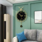 Modern luxury wall clock with gold accents in a stylish living room setting.