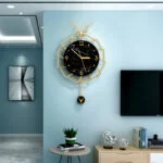 Modern luxury wall clock with gold accents in a stylish living room setting.