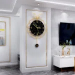 Luxury black and gold wall clock with deer design in modern living room decor.