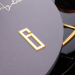 Modern luxury wall clock with gold accents and sleek design.