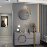 Modern luxury wall clock in a stylish living room with decorative accessories and LED lighting.