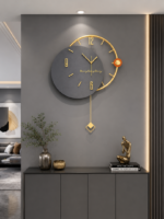 Modern luxury wall clock with gold accents in a stylish living room setting.