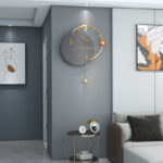 Modern luxury wall clock in a stylish living room with abstract wall art.