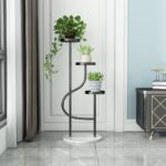 Modern indoor planter stand with three levels and decorative plants in a luxury home setting.