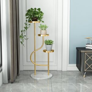 Elegant gold indoor planter with three levels, featuring lush green plants, in a modern living room setting.