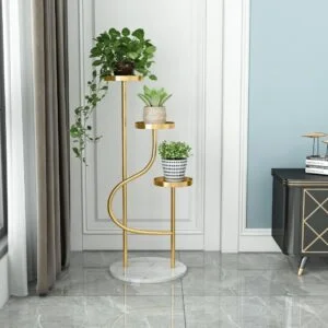 Elegant gold indoor planter with three levels, featuring lush green plants, in a modern living room setting.