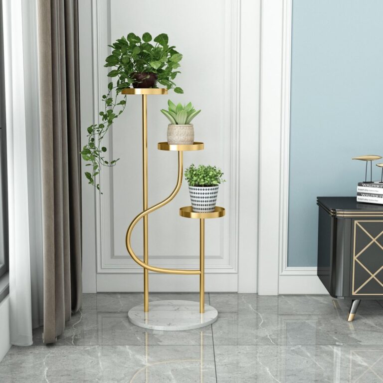 Elegant gold indoor planter with three levels, featuring lush green plants, in a modern living room setting.