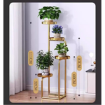 Gold metal indoor planter stand with multiple levels and potted plants, modern home decor.