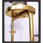 Gold metal plant stand with modern design for home decor.
