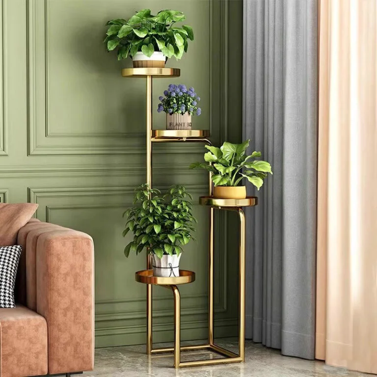 Modern gold metal plant stand with green plants in a stylish living room.