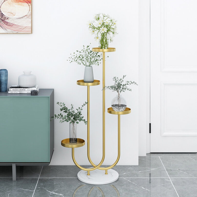 Modern gold metal planter stand with glass vases and greenery in a stylish home interior.