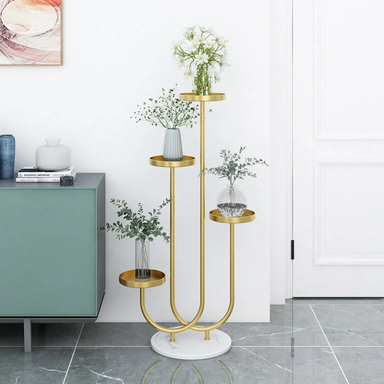 Modern gold metal planter stand with glass vases and greenery in a stylish home interior.