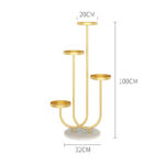 Gold decorative candle holder with four tiers on a marble base.
